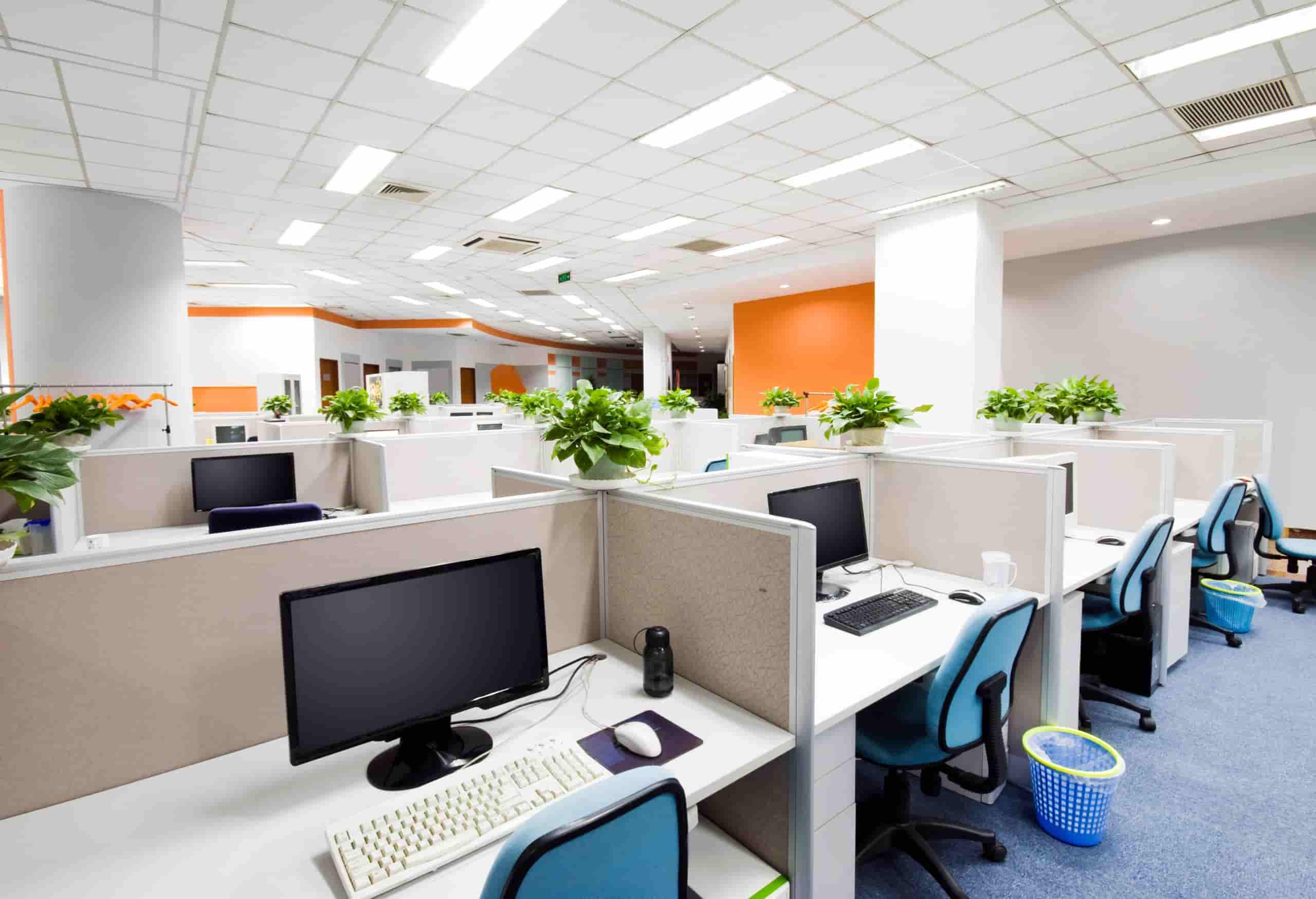Modern open-plan office workspace with desks and computers