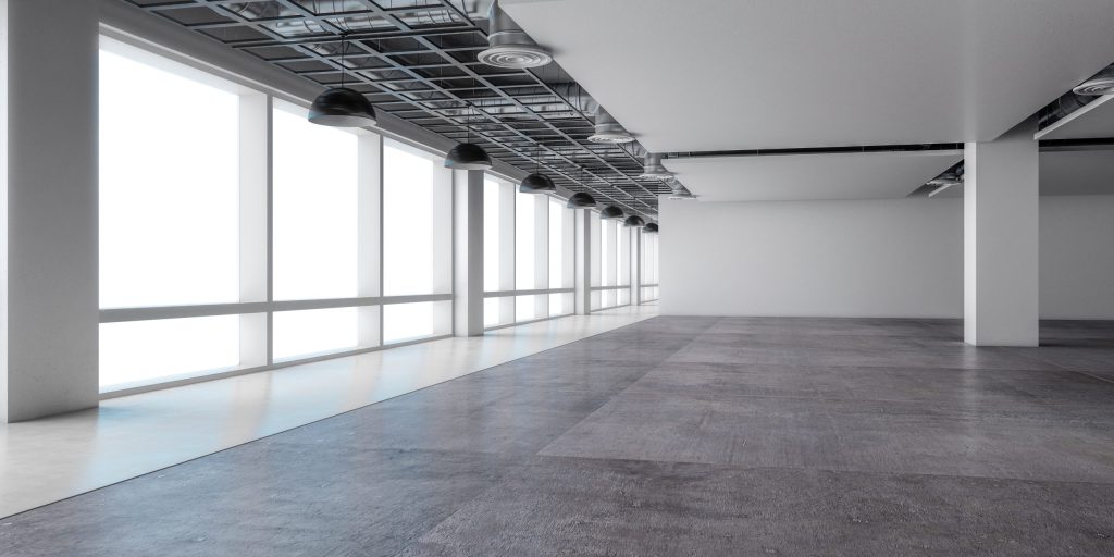 Empty unfinished commercial space with exposed ceiling, concrete floor, and floor-to-ceiling windows