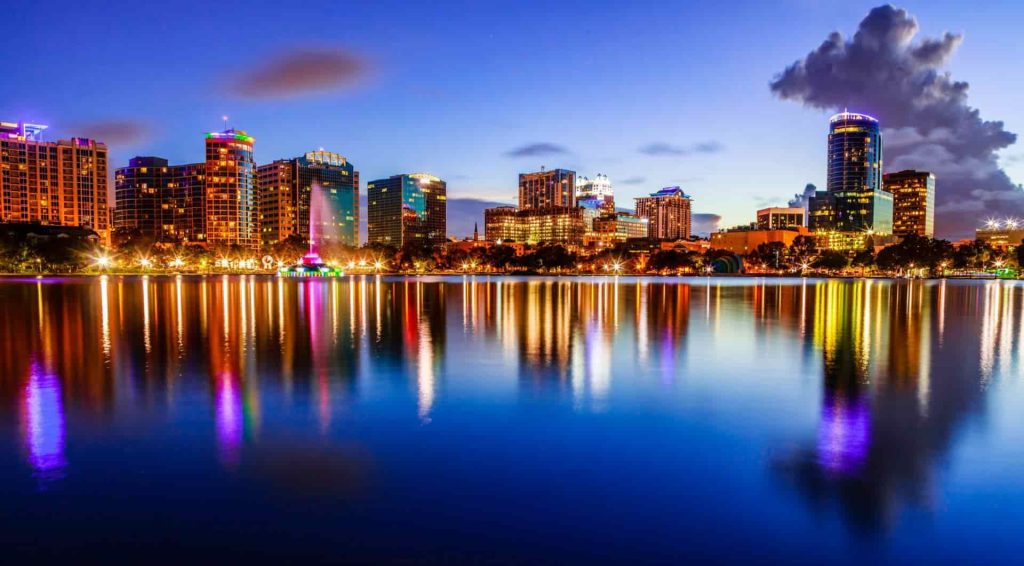 Waterfront city skyline reflected at night