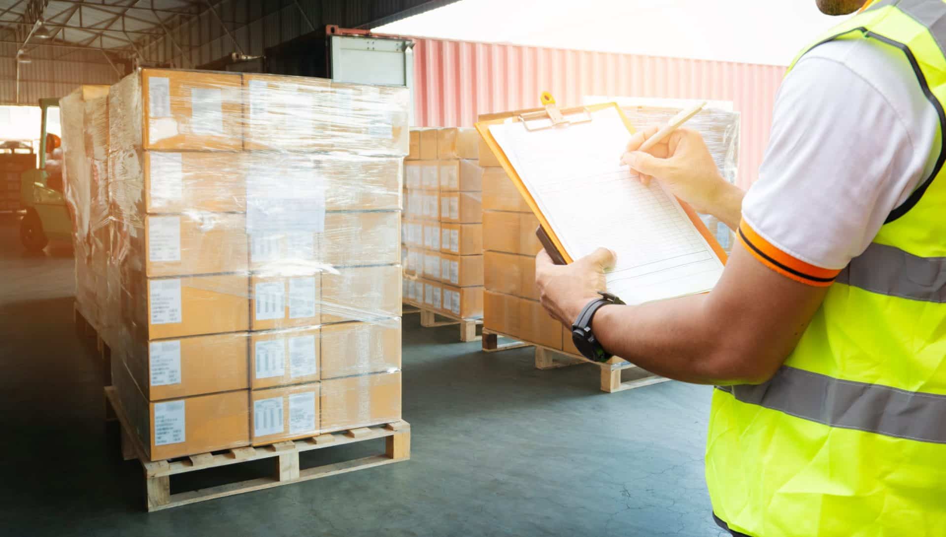 Warehouse worker inspecting shipment and inventory