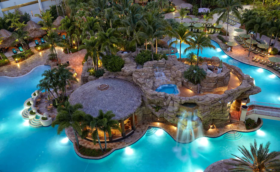 Aerial view of tropical beachfront resort with swimming pools
