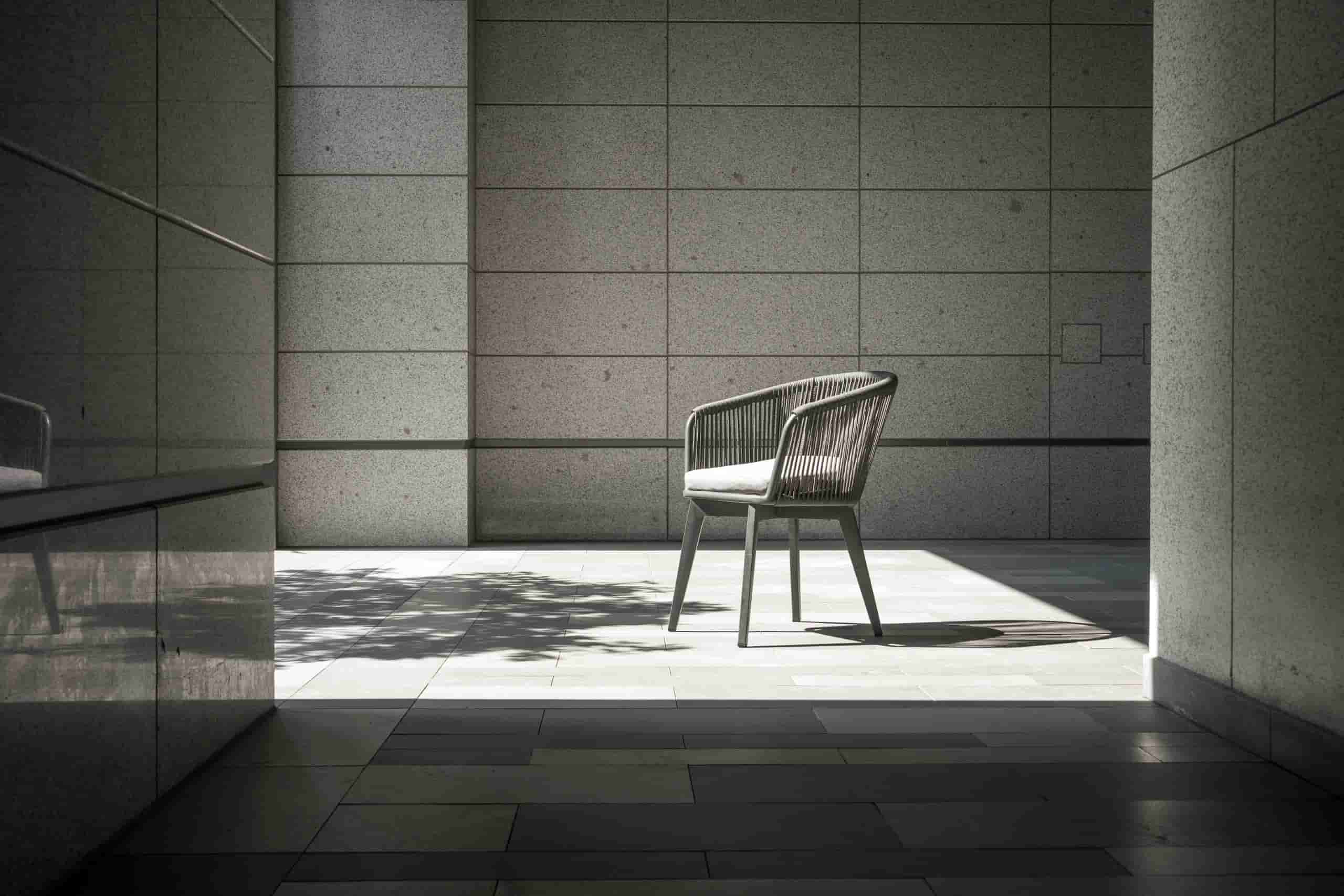 Modern minimalist interior with chair and spotlight